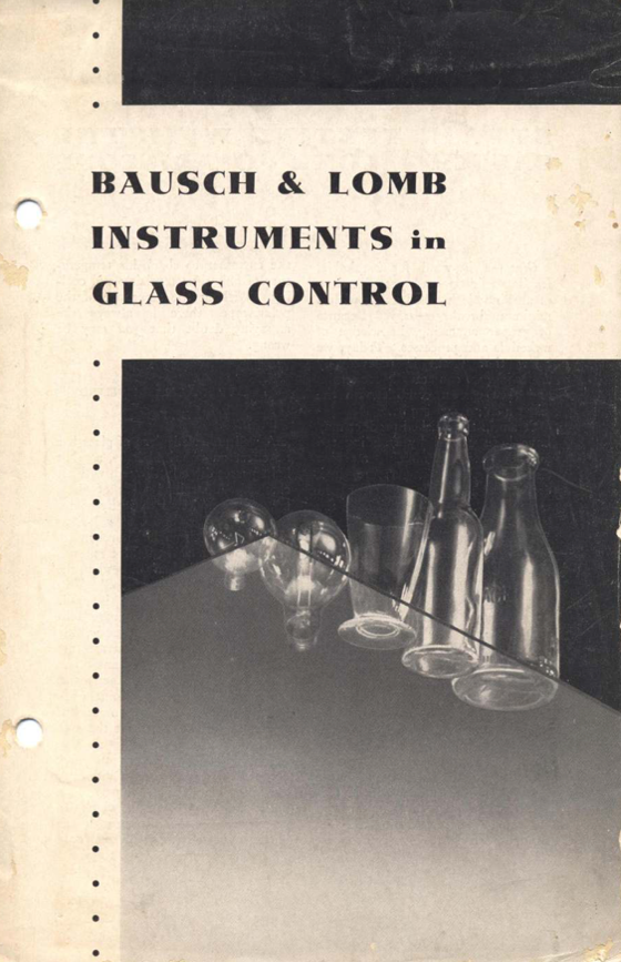 A book with a glass bottle and glasses
Description automatically generated