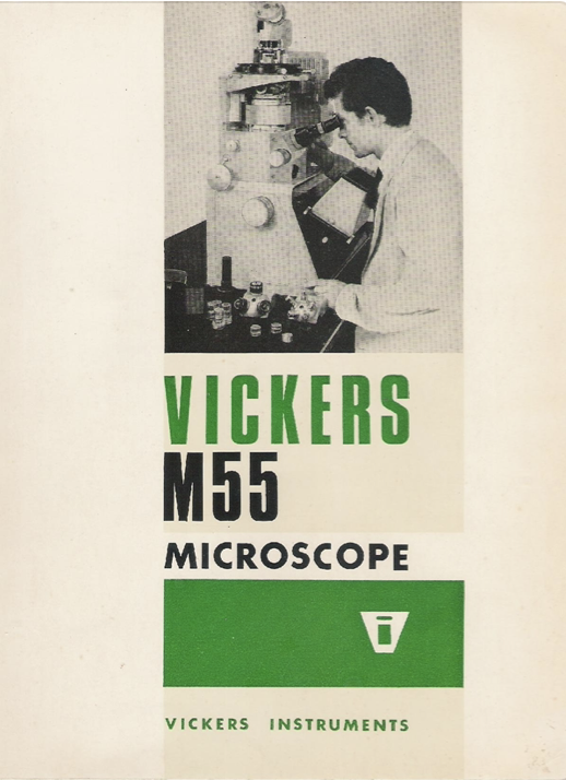 A person looking through a microscope
Description automatically generated