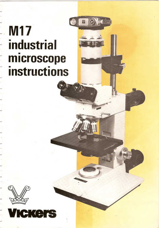 A white and black microscope
Description automatically generated