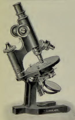 A picture containing microscope, indoor
Description automatically generated
