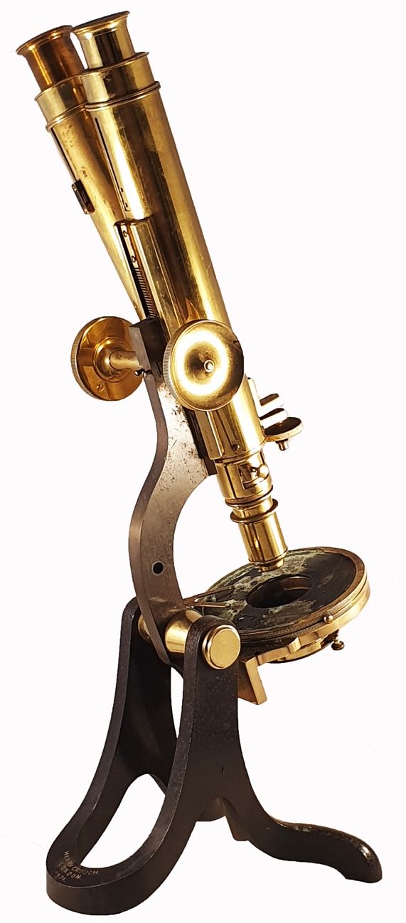 A close-up of a gold microscopeDescription automatically generated
