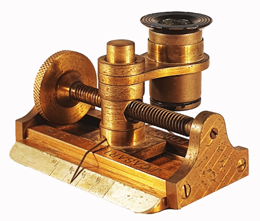 A gold metal device with a screw
Description automatically generated