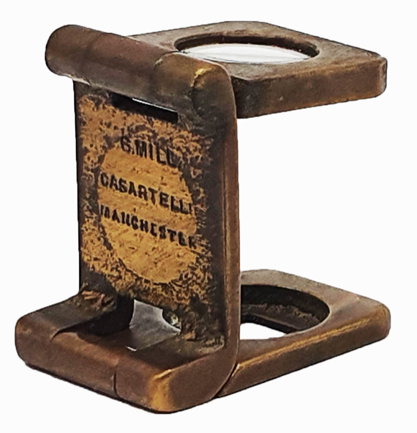 A metal object with a magnifying glass
Description automatically generated