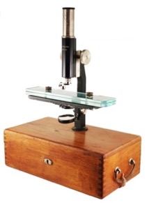 A microscope on a wooden table
Description automatically generated