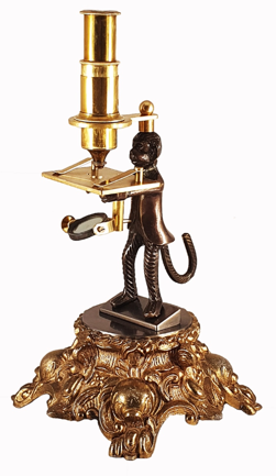 A statue of a monkey holding a candle
Description automatically generated